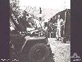 BALIKPAPAN AREA, BORNEO. 1945-09-07. TRANSPORT PERSONNEL WORKING ON A JEEP MOTOR IN THE CAMP OF 2_14TH INFANTRY BATTALION ON THE EDGE OF MANGGAR AIRSTRIP.