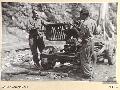 BARGES HILL, CENTRAL BOUGAINVILLE, 1945-06-26. GNR K. URWIN (1) AND L-BDR N. HEALEY (2), MEMBERS OF 2 MOUNTAIN BATTERY DISMANTLING JEEPS