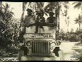 Bougainville, Solomon Islands. Three servicemen leaning over the windscreen of a RAN jeep numbered 0844. (Donor P White)
