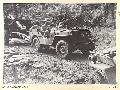 BOUGAINVILLE. 1945-05-25. A JEEP TOWING A 25-POUNDER ALONG BUIN ROAD