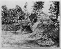Wadesboro, North Carolina. Ford GP Jeep on maneuvers crossing rough terrain pulling a thirty-seven millimeter anti-tank gun. Battery D of the Fourty-four Division Anti-tank, Second Corps 41 Nov.