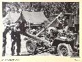 BOUGAINVILLE. 1945-08-30. CRAFTSMEN OF 2_4 ARMOURED REGIMENT WORKSHOP AT A FORWARD WORKSHOP, ATTEMPTING TO STRAIGHTEN A JEEP CHASSIS DAMAGED BY A FALLING TREE