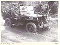 BOUGAINVILLE_1945-07-16_BRIG J_FIELD_ADMINISTRATIVE COMMAND_HQ 3 DIVISION_TRAVELLING IN A JEEP ALONG THE MUDDY BUIN ROAD EAST OF THE OGORATA RIVER ON HIS WAY TO VISIT HQ 29 INFANTRY BRIGADE