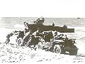 CAIRNS, QLD. 1943-06-25. ASSISTING BOGGED JEEP OUT OF SOFT SAND DURING COMBINED INVASION EXERCISES.