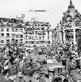 Allied forces and French civilians celebrating the liberation of Paris outside the Hotel de La Ville