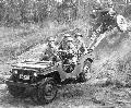 Wadesboro, North Carolina. Jeep on maneuvers crossing rough terrain pulling a thirty-seven millimeter anti-tank gun.