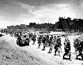 Dec. 26, 1943: U.S. Marines march ashore as they arrive in six landing crafts at Cape Gloucester on the northwestern coast of New Britain Island, New Guinea.