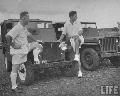 Inspector and estate manager standing in front of jeep.Cambodia  July 1948