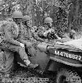 M4678822_Airborne troops, with blackened faces and camouflaged with grass, in a jeep, December 1942
