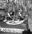 CM5826948  2nd Provost Company, Canadian Provost Corps (C.P.C.), exchanging notes on the hood of their jeep in the Reichswald, Germany, 20 March 1945.