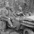 M4768822 MB Airborne troops, with blackened faces and camouflaged with grass, in a jeep, December 1942.