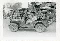 2068391 GPW American Army jeep on street with horse-drawn carts and rickshaws - Manila, Philippine Islands, ca. 1945